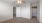 a room with a window and ceiling fan